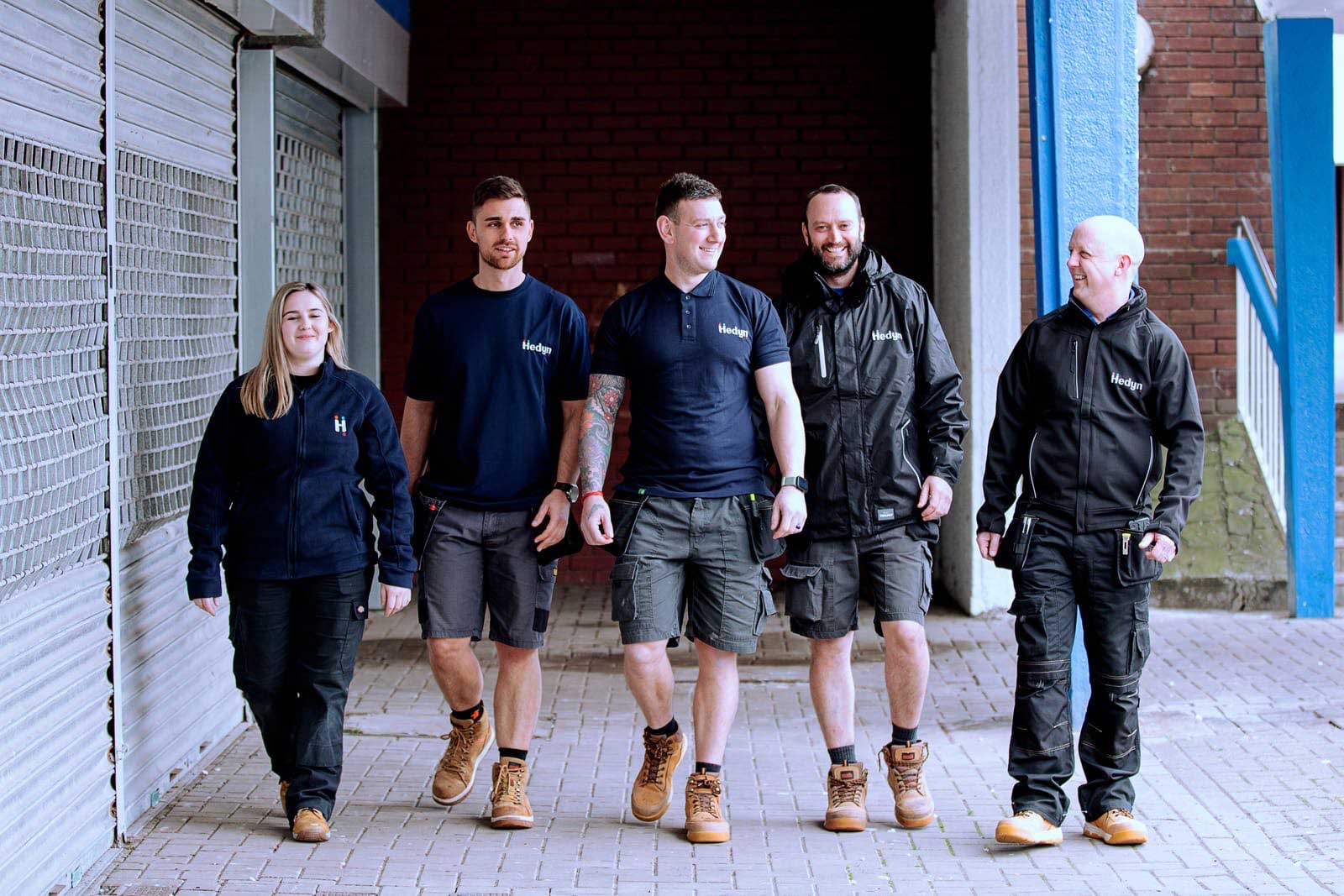 Hedyn trades and estates colleagues walking down a street in uniform.