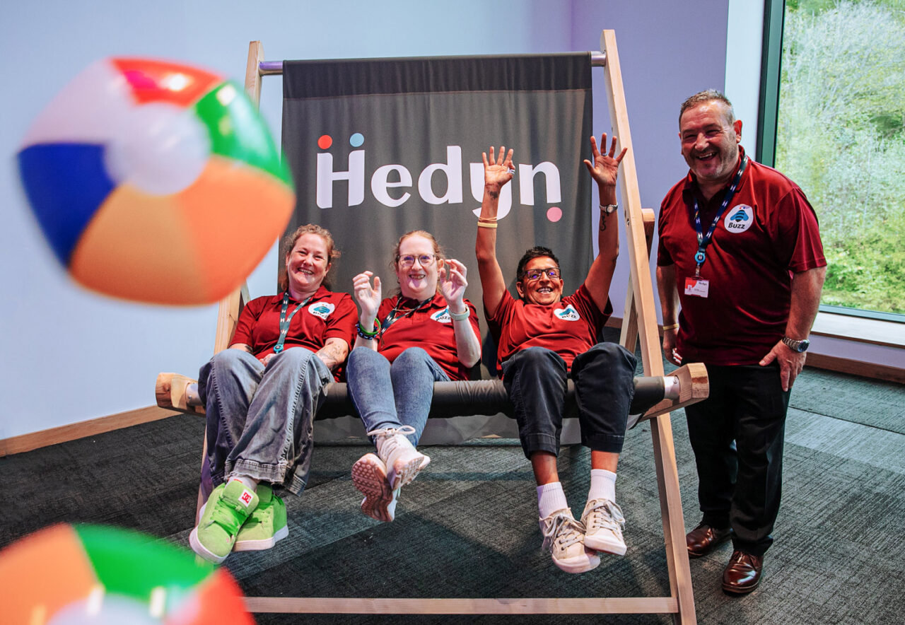 Some members of our residents’ panel Buzz, sit and smile together on a giant deck chair at our recent staff conference.